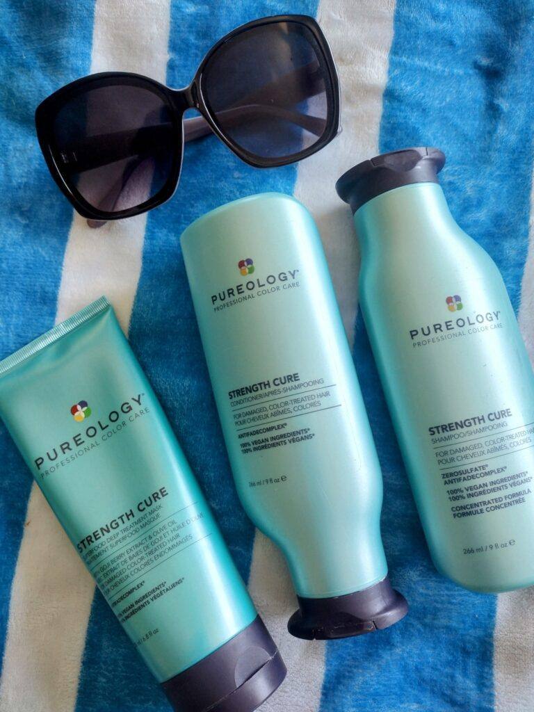 Pureology Strength Cure shampoo and conditioner next to beach towel